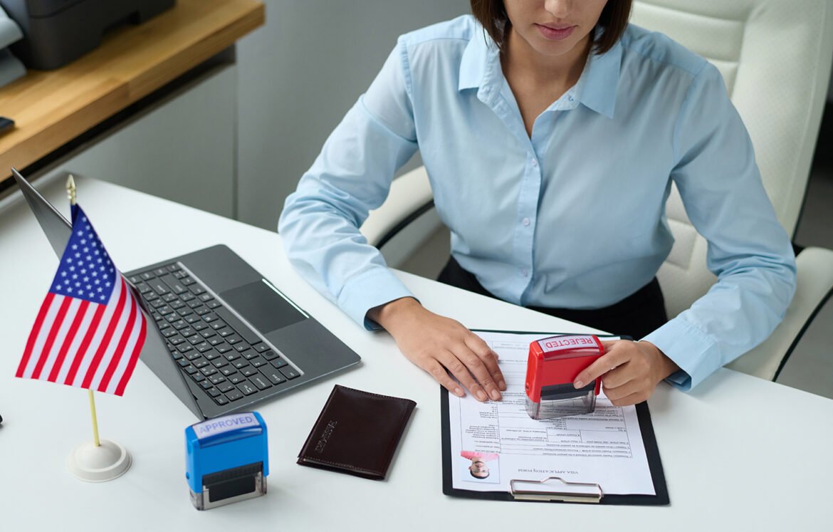 High angle view of professional specialist rejecting visa for tourist putting stamp on document