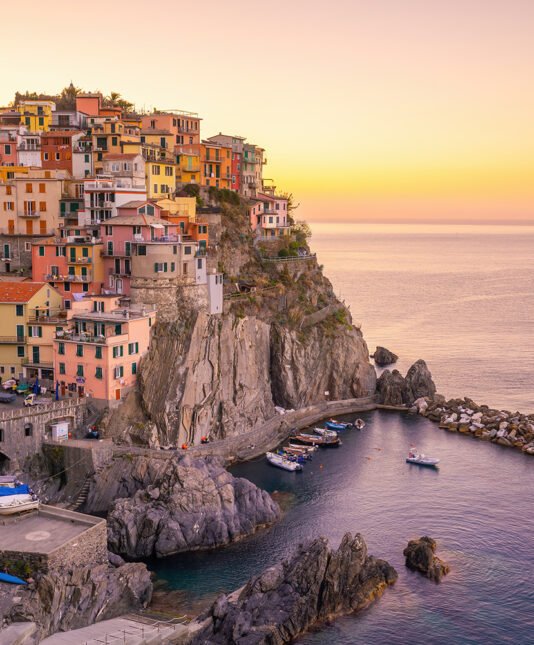 Colorful cityscape of buildings over Mediterranean sea, Europe, Cinque Terre, traditional Italian architecture